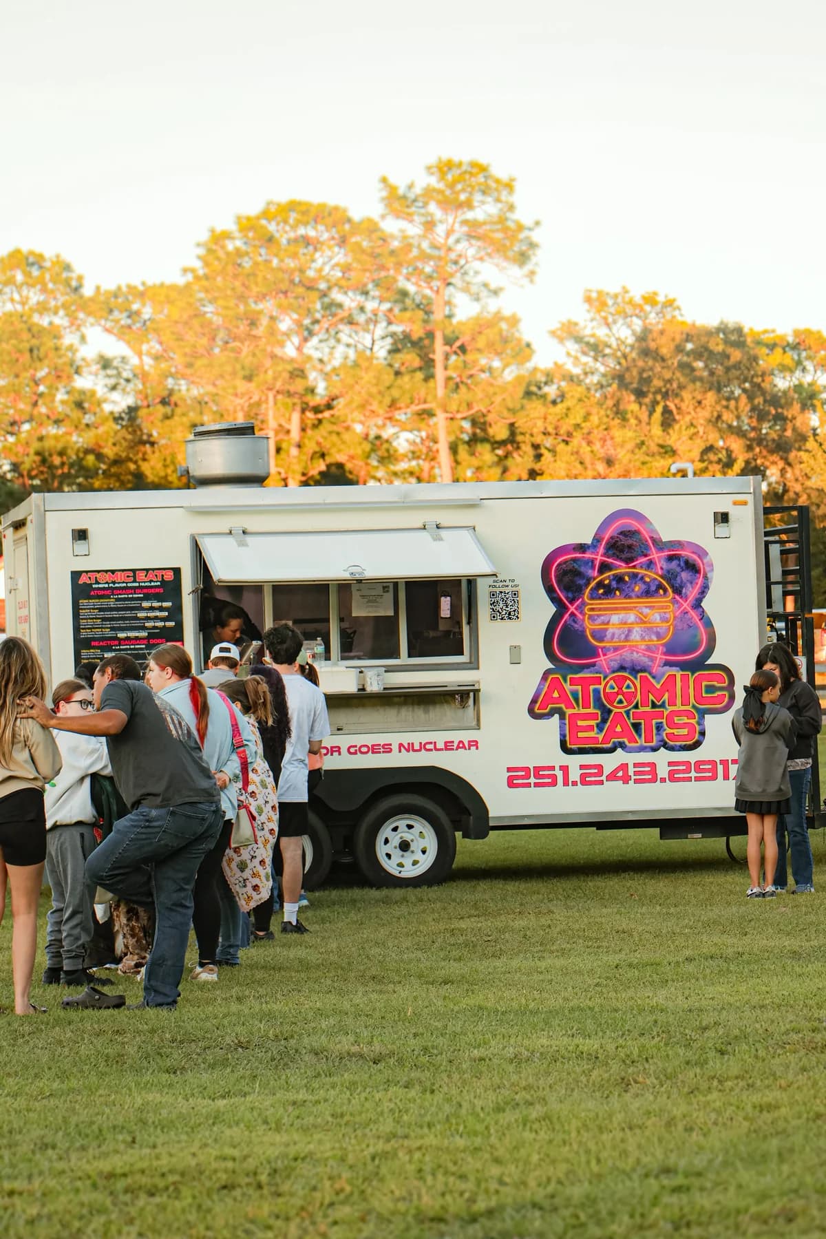 Customers at the Atomic Eats food truck during family movie night