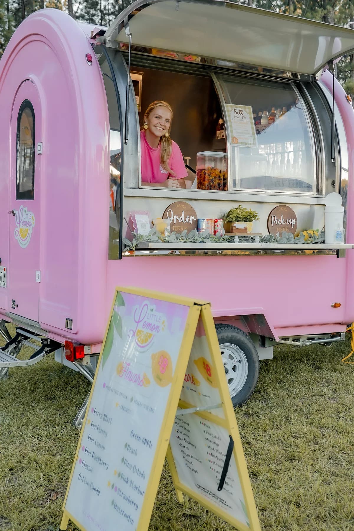 Little Lemon Co. owner at the window of her food trailer